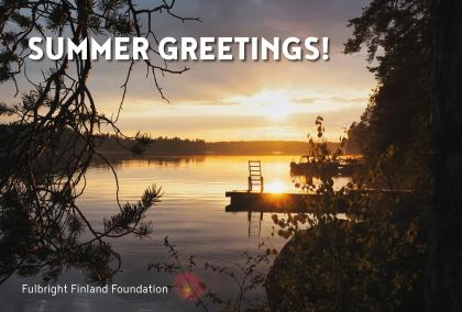 View of a lake during a sun set with text "Summer Greetings!" in the left corner