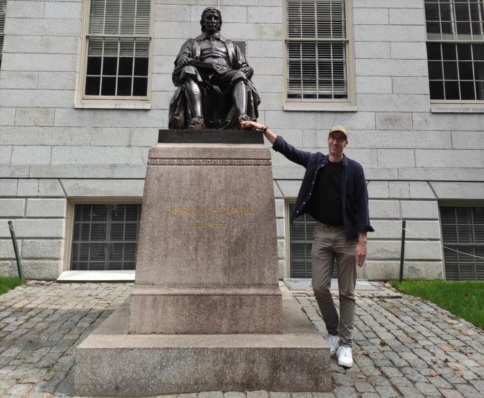 Riku Laine rubbing the foot of John Harvard's statue