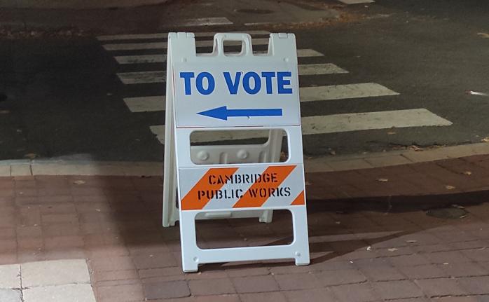 A road sign saying "To Vote" and arrow pointing to left.