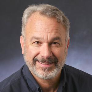 Person in front of a grey background looking at the camera