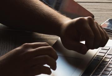 Stock photo of man using a laptop